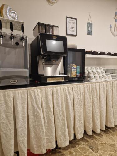 a table with a table cloth on it with a tv on it at Hotel AnnaMare in Rimini