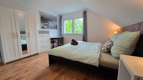 a small bedroom with a bed and a window at Ferienwohnung in Eckenhagen in Reichshof 