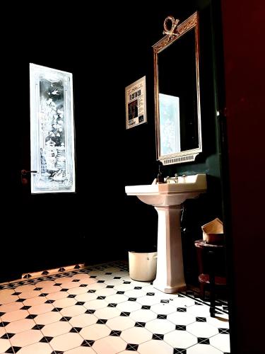 a bathroom with a sink and a mirror at The Cotton Suites B&B in Deerlijk