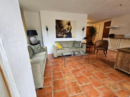 a living room with two couches and a table at Font Neuve in Souillac