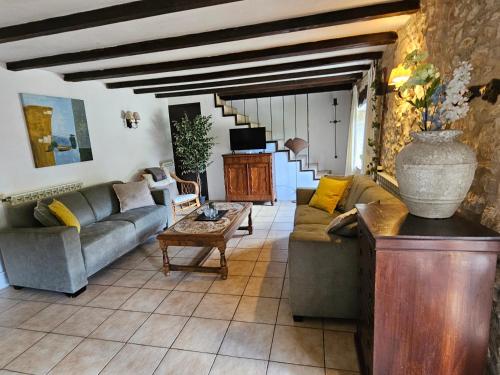 a living room with a couch and a table at Font Neuve in Souillac