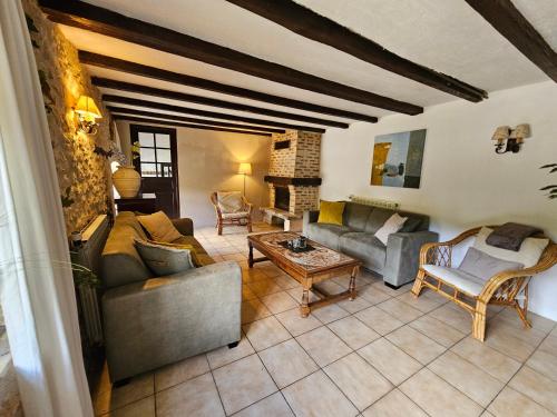 a living room with two couches and a fireplace at Font Neuve in Souillac
