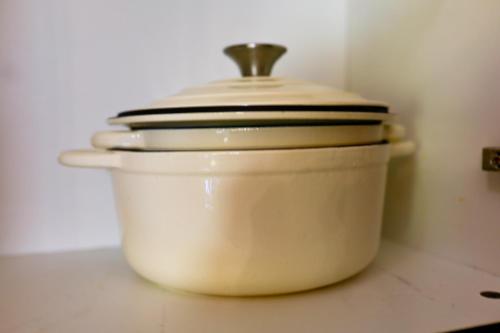 a white pot with a lid sitting on a counter at Golf Estate Living 1BR Apartment in Jackal Creek in Roodepoort