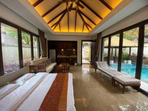 a bedroom with a large bed and a pool at Perfume Bay Tianhai Meiya B&B in Lingshui
