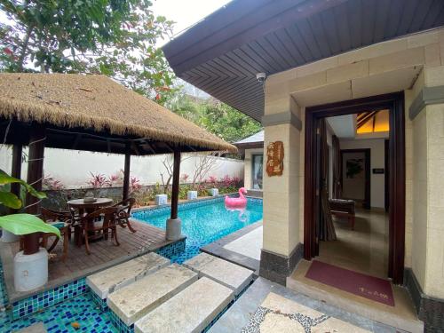 a villa with a swimming pool and a house at Perfume Bay Tianhai Meiya B&B in Lingshui