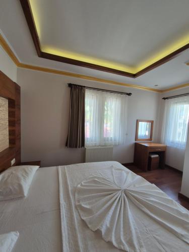 Postel nebo postele na pokoji v ubytování Dinara Apart Hotel