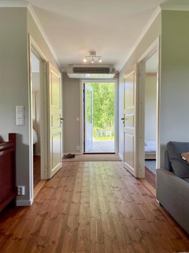 an empty living room with a door and a couch at Tjänstebostaden på Storöns bondgård in Otterbäcken
