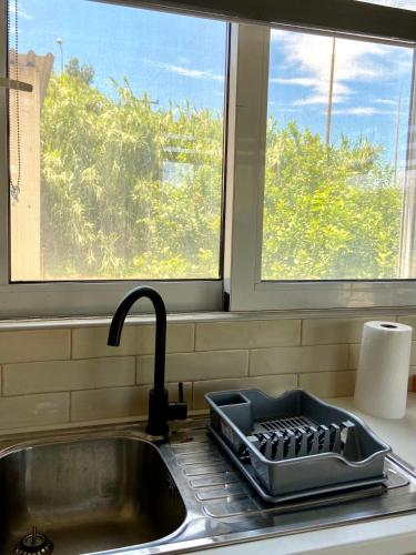 a kitchen sink with a tray on top of it at Lemon Loft in Preveza