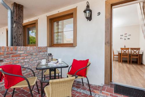 a table and chairs in a room with a brick wall at APARTAMENTY STARE SARBINOWO in Sarbinowo