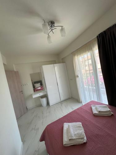 a bedroom with a bed with two towels on it at Natalia House in Nikiti