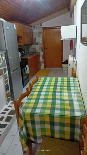 a kitchen with a table with a checkered table cloth on it at Yiannis House in Kalabaka