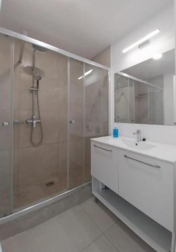 a bathroom with a shower and a sink and a mirror at Studio Deluxe at Blaxy RESORT Olimp - vedere superba la mare in Olimp