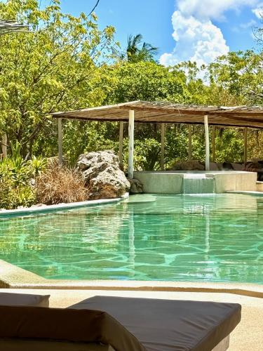 a swimming pool with a gazebo at Rock and Sea Resort in Watamu