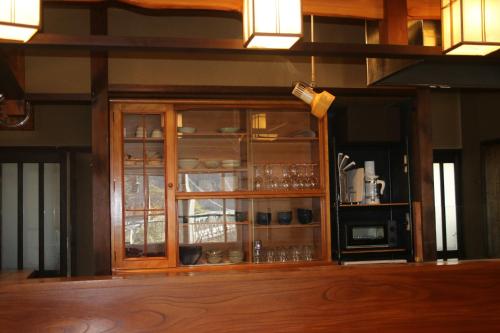 a wooden cabinet with glass doors in a kitchen at Tranquil Mountain Getaway - Breathtaking Scenery right next to Nakasendo Trail in Nagiso