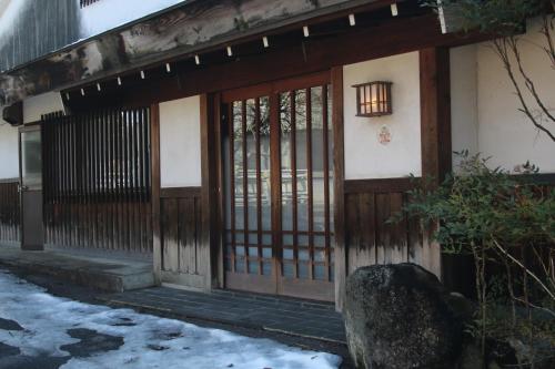 an entrance to a building with a wooden door at Tranquil Mountain Getaway - Breathtaking Scenery right next to Nakasendo Trail in Nagiso