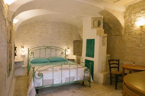a bedroom with a bed in a stone wall at Dimora d Artista in Terlizzi