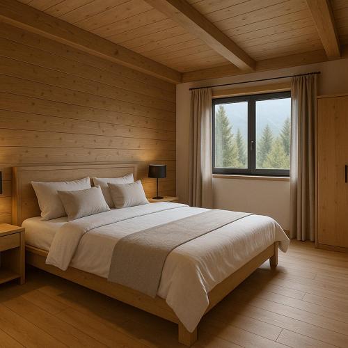 une chambre avec un grand lit et une grande fenêtre dans l'établissement Les chalets Super Geants, à Saint-François-Longchamp