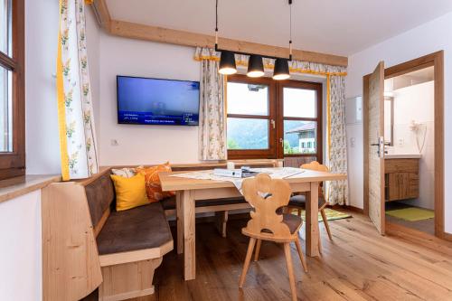 a dining room with a table and a couch at Hagerhof in Walchsee
