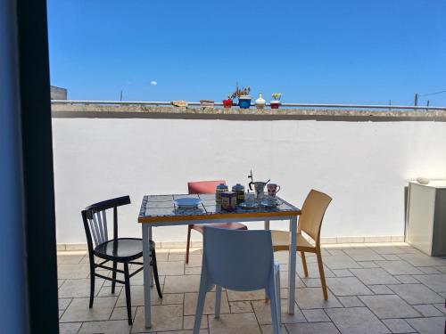 a table and chairs on a patio with a view at Versante est in Casamassella