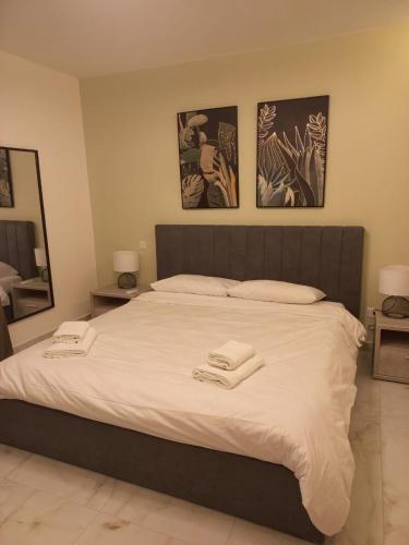 a bedroom with a large bed with two towels on it at Hal Wardija Resort Apartments in Qala