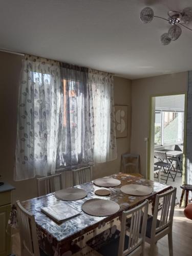 une cuisine avec une table avec des chaises et une salle à manger dans l'établissement F3 Meublé Rdc Amélie-les-Bains, à Amélie-les-Bains-Palalda