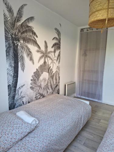 a bedroom with a bed with a mural of palm trees at Chez Léonie in Sainte-Mère-Église