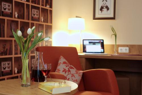 a room with a table with a laptop on a desk at Hotel Pension Fortuna in Bad Bevensen