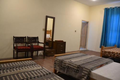 Postel nebo postele na pokoji v ubytování West End Lodges