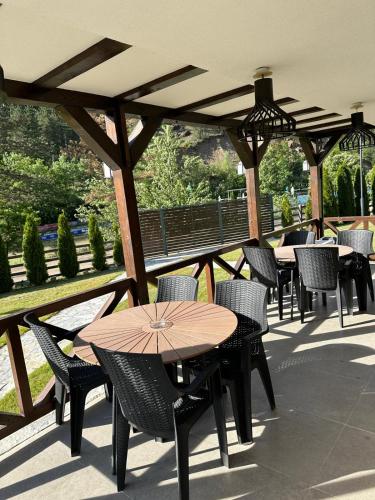 a group of tables and chairs on a patio at Uvački Eko Biser 
