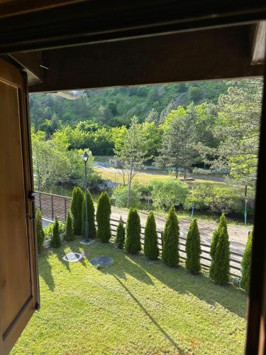 a view of a garden from a window at Uvački Eko Biser 