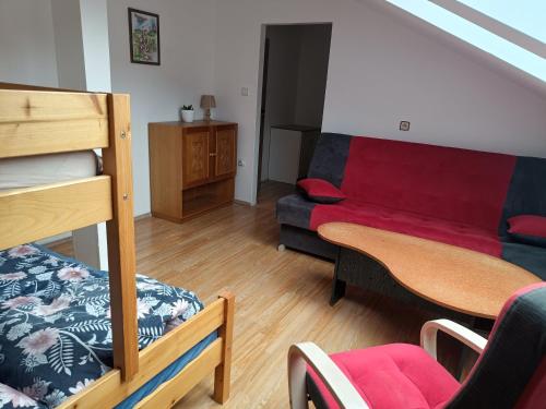 a living room with a bunk bed and a couch at Hobití doupě in Stražisko