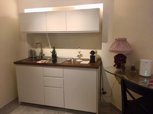 a kitchen with a sink and a desk with a lamp at Loft 3B in Bari