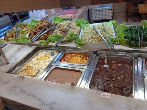 a buffet filled with lots of different types of food at Princesa do Vale Hotel in Aparecida