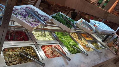 a buffet filled with lots of different types of food at Princesa do Vale Hotel in Aparecida