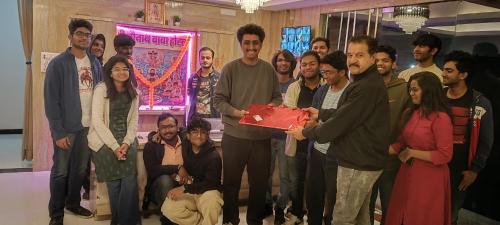 a group of people standing around a man holding a cake at Shree 9NB Hotels, Pithampur in Indore