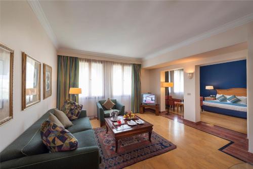 a living room with a couch and a table at Reef Oasis Beach Aqua Park Resort in Sharm El Sheikh