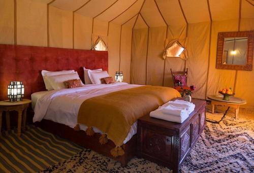 a bedroom with a large bed in a tent at Fantastic desert camp in Oulad Akkou