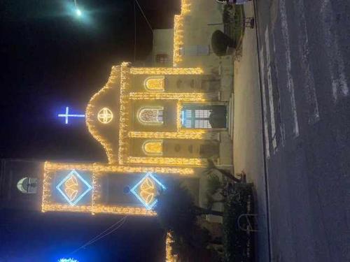 a building with lights on the side of it at night at PiazzaItaliaSuite appartamento con terrazza in Cagliari