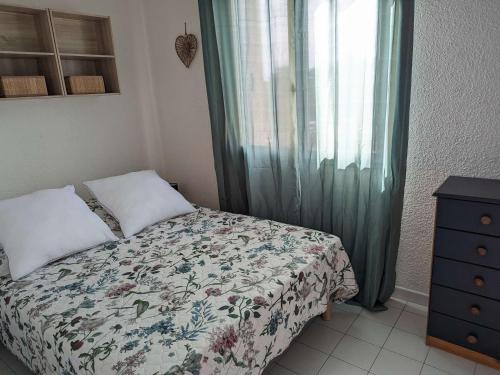 une chambre avec un lit, une commode et une fenêtre dans l'établissement Appartement 2 pièces avec piscine, parking privé et accès direct à la plage - FR-1-387-50, à Marseillan