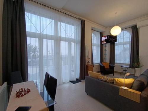 a living room with a couch and a table at Panorama Hill in Szombathely