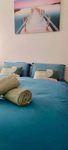 - un lit bleu avec une photo de jetée dans l'établissement nirvana, à Fleurieux-sur-lʼArbresle