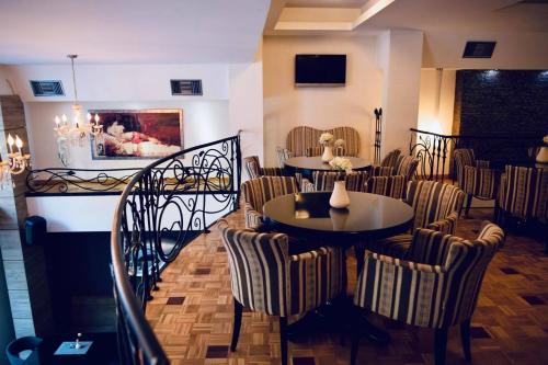 a dining room with tables and chairs in a restaurant at Hotel Bela Kuka in Bitola