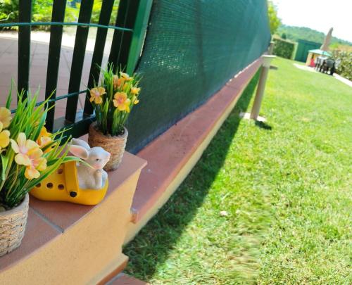 a bench with flowers and a stuffed animal on it at Villa Marta in Città della Pieve
