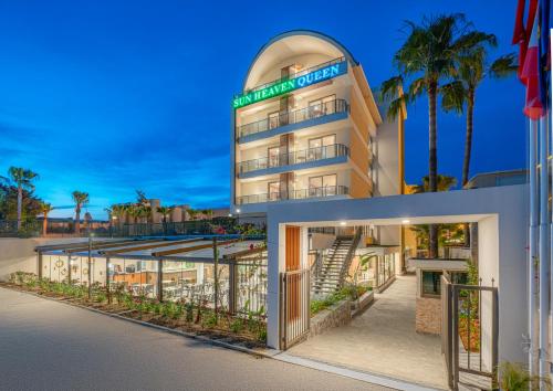 an exterior view of a building with palm trees at Sun Heaven Queen in Alanya