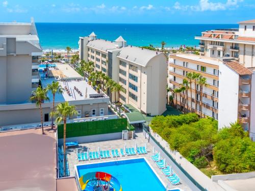 an aerial view of a resort with a pool and the ocean at Sun Heaven Queen in Alanya