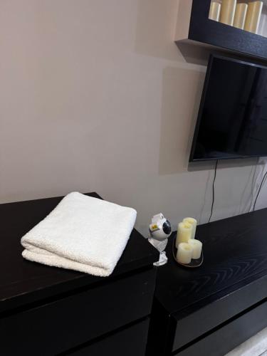 a black table with a towel and two candles on it at Samal deluxe in Almaty