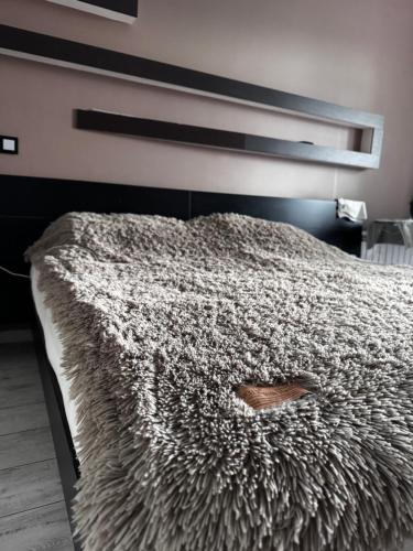 a bedroom with a bed with a brown shoe on it at Samal deluxe in Almaty