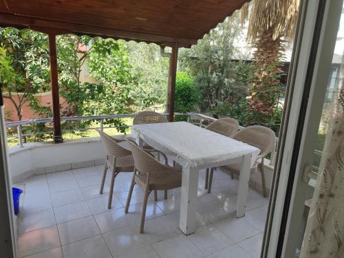 a white table and chairs on a porch at Huzurlu Triplex Villa in Bozyazı