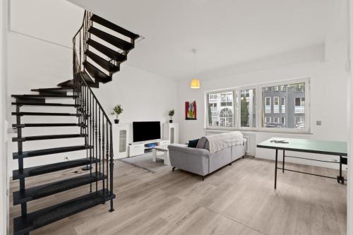 a living room with a spiral staircase and a couch at Geräumiges Familienhaus Köln in Niederdorla