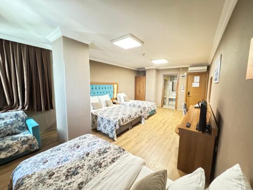 a hospital room with two beds and a television at Golden Lounge Hotel in Istanbul